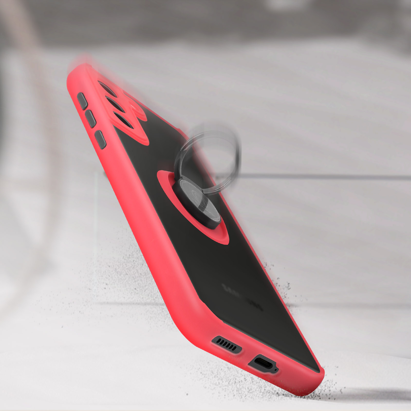 Coque de téléphone rouge et noire avec un porte-anneau. La coque est inclinée et tombe.