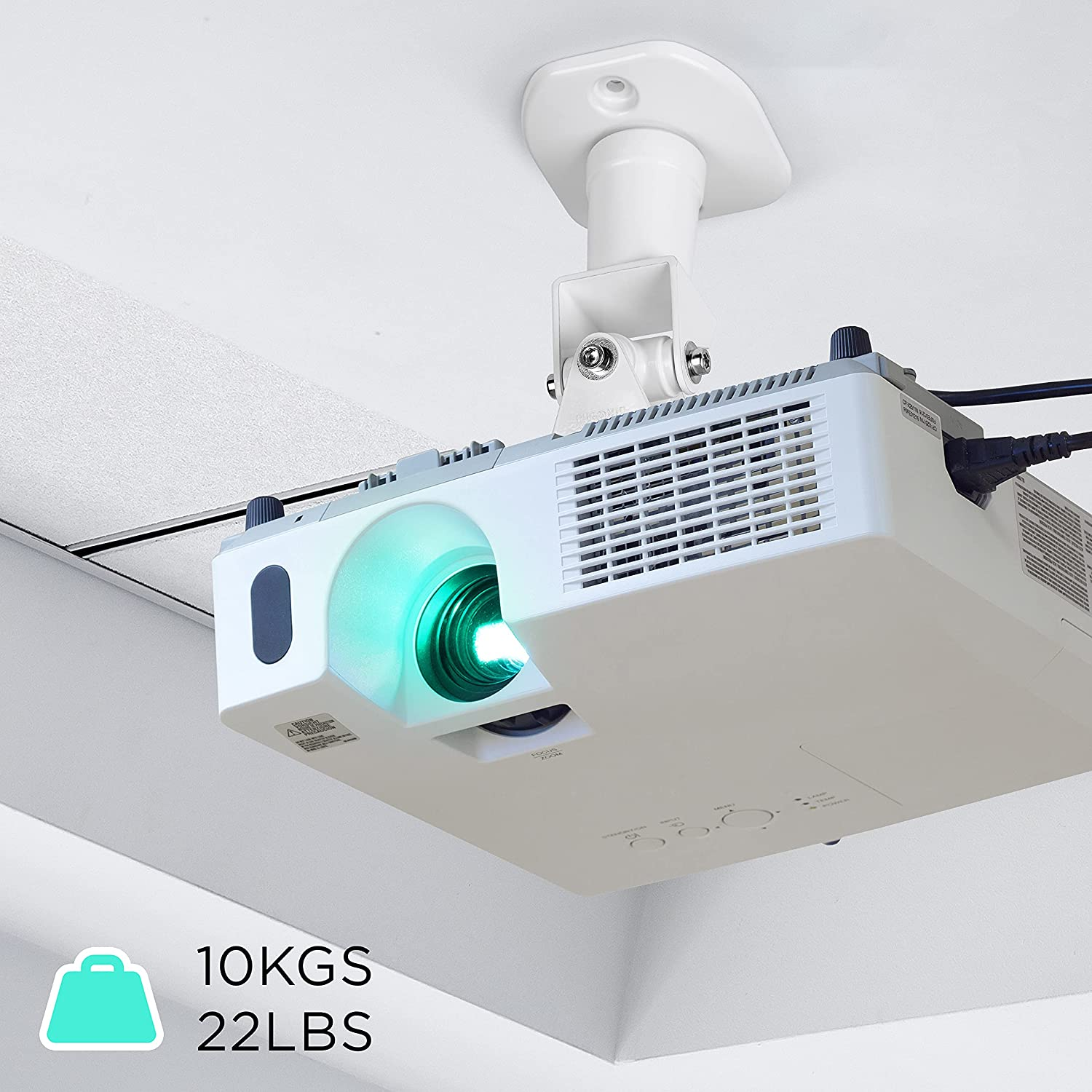 Un proyector blanco montado en un techo con un haz de luz verde. El texto muestra 10KGS y 22LBS.