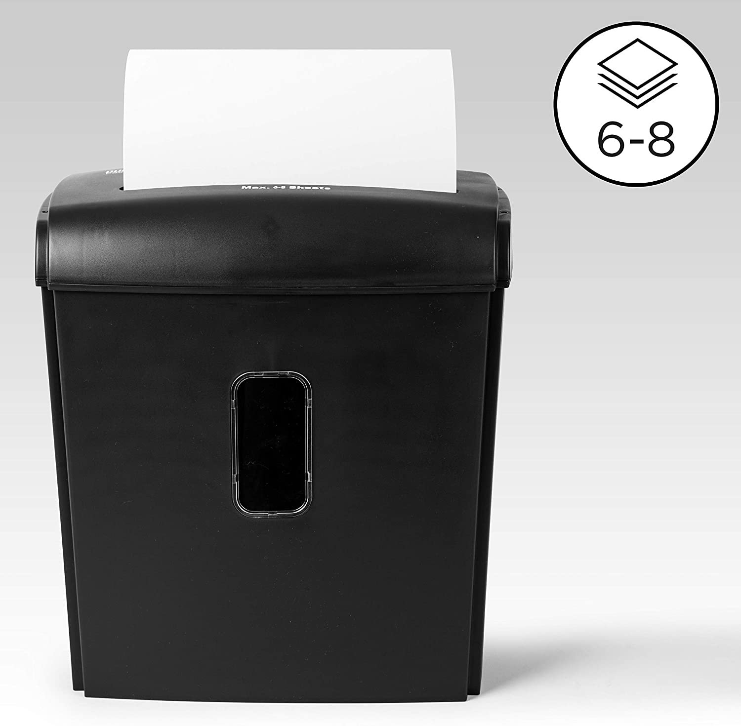 Schwarzer Aktenvernichter mit geschreddertem Papier. Zeigt 6-8 Blatt Kapazität.