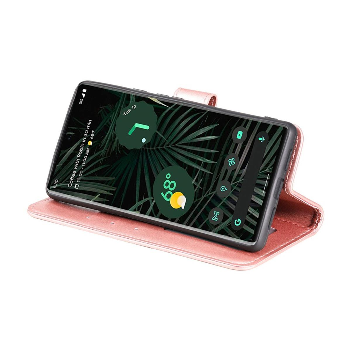 Ein Telefon in einem rosa Gehäuse. Der Bildschirm zeigt Uhrzeit und Kalender an. Das Gehäuse ist geöffnet.