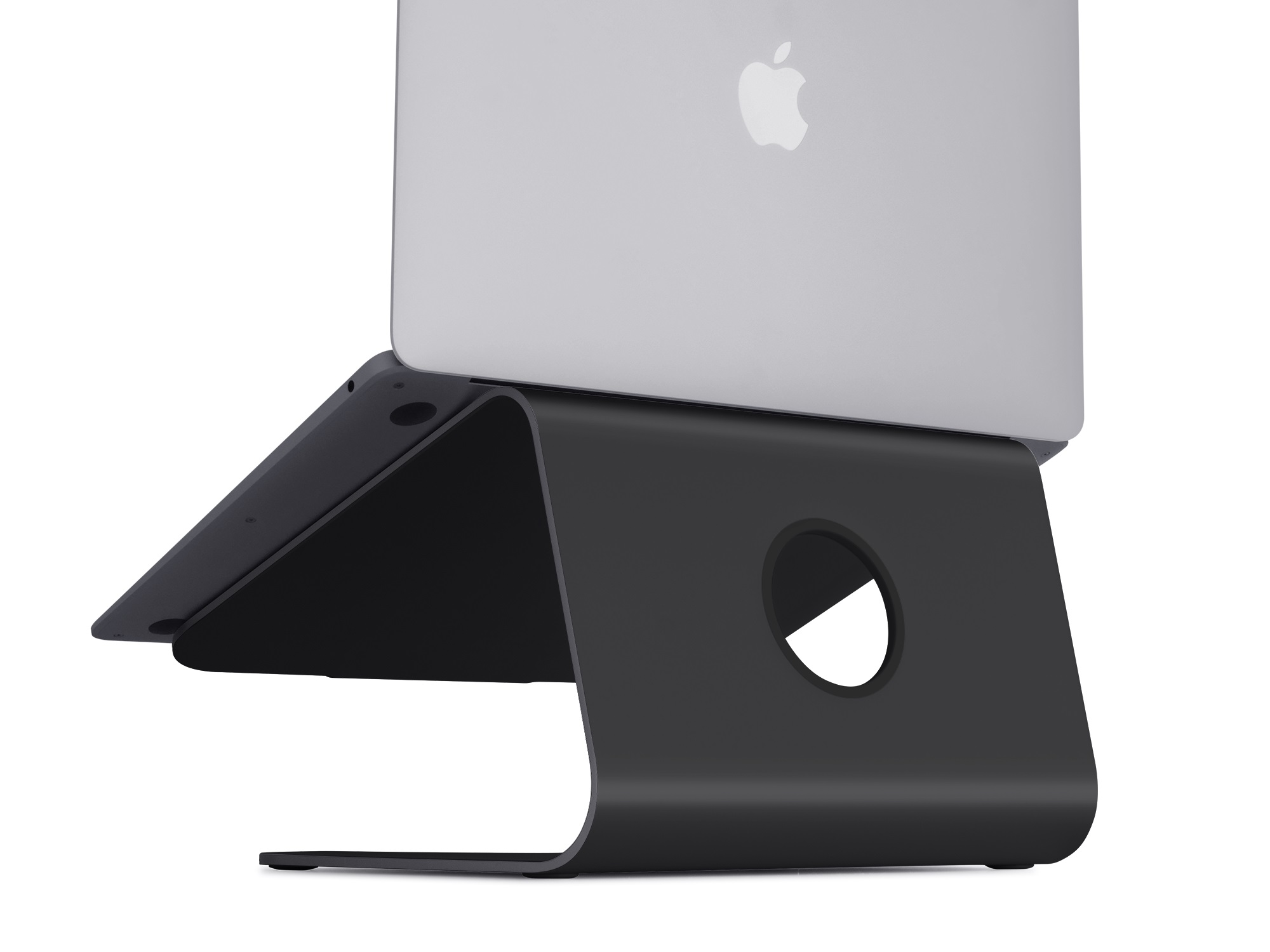 Black laptop stand. Silver laptop on top. Apple logo visible. Curved design. White background.
