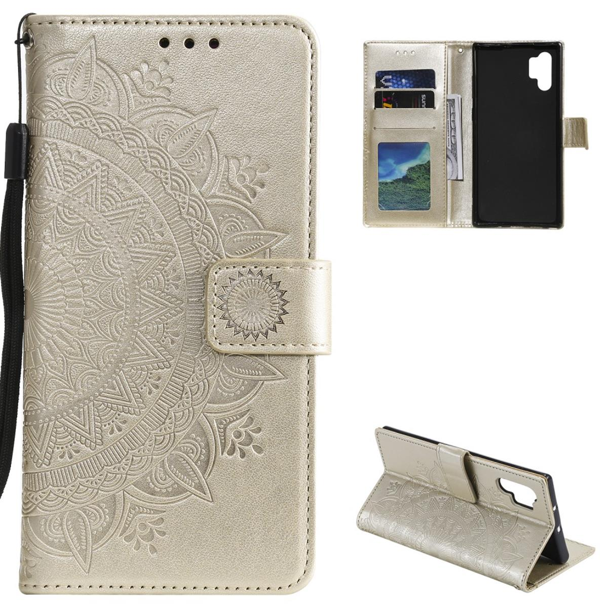 Goldene Handyhülle mit Mandala-Design. Zeigt Kartenfächer und ein Telefon im Inneren. Hat eine schwarze Handschlaufe.