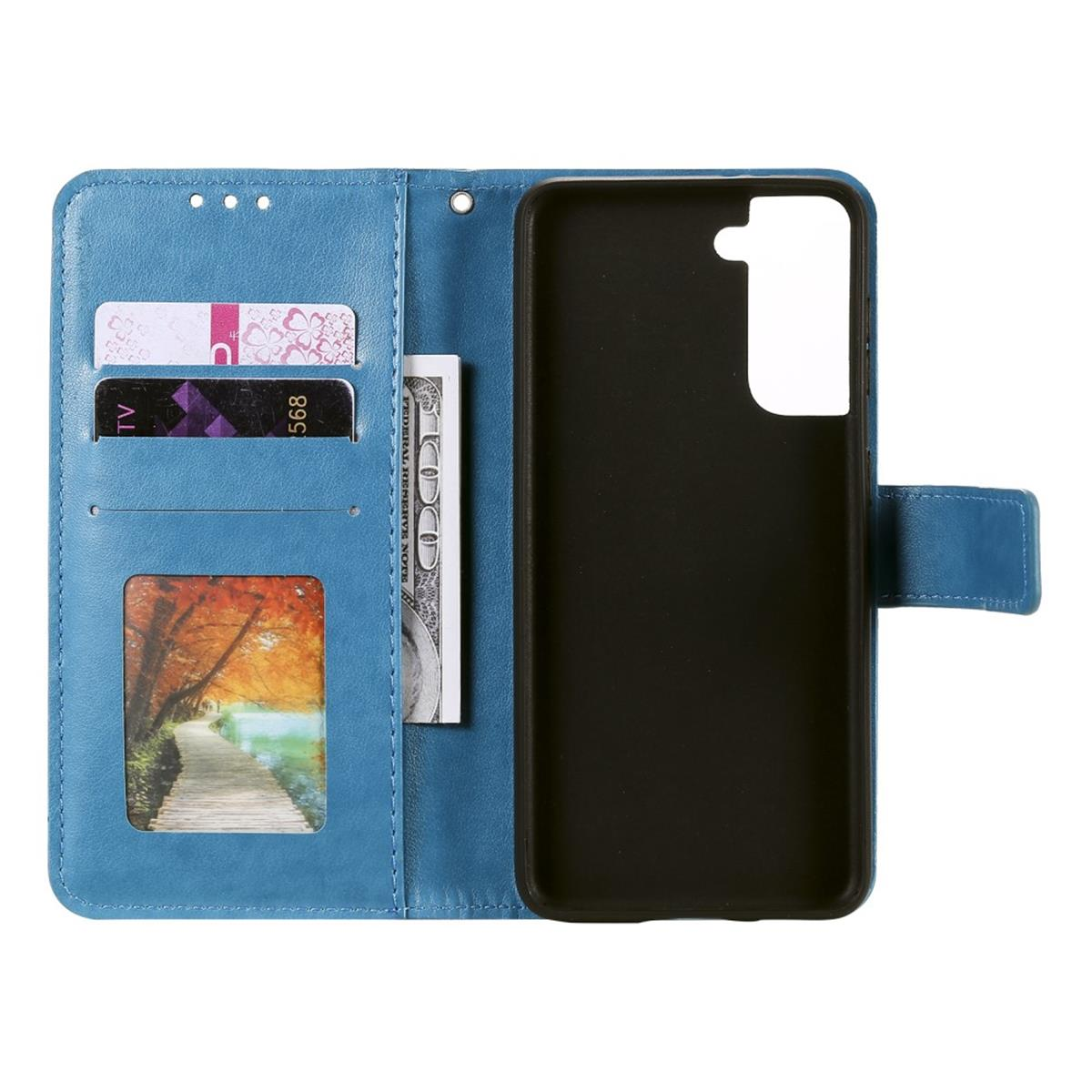 Blaue Handyhülle offen, Karten, Geld und Telefon zeigend. Ein Landschaftsbild ist sichtbar.