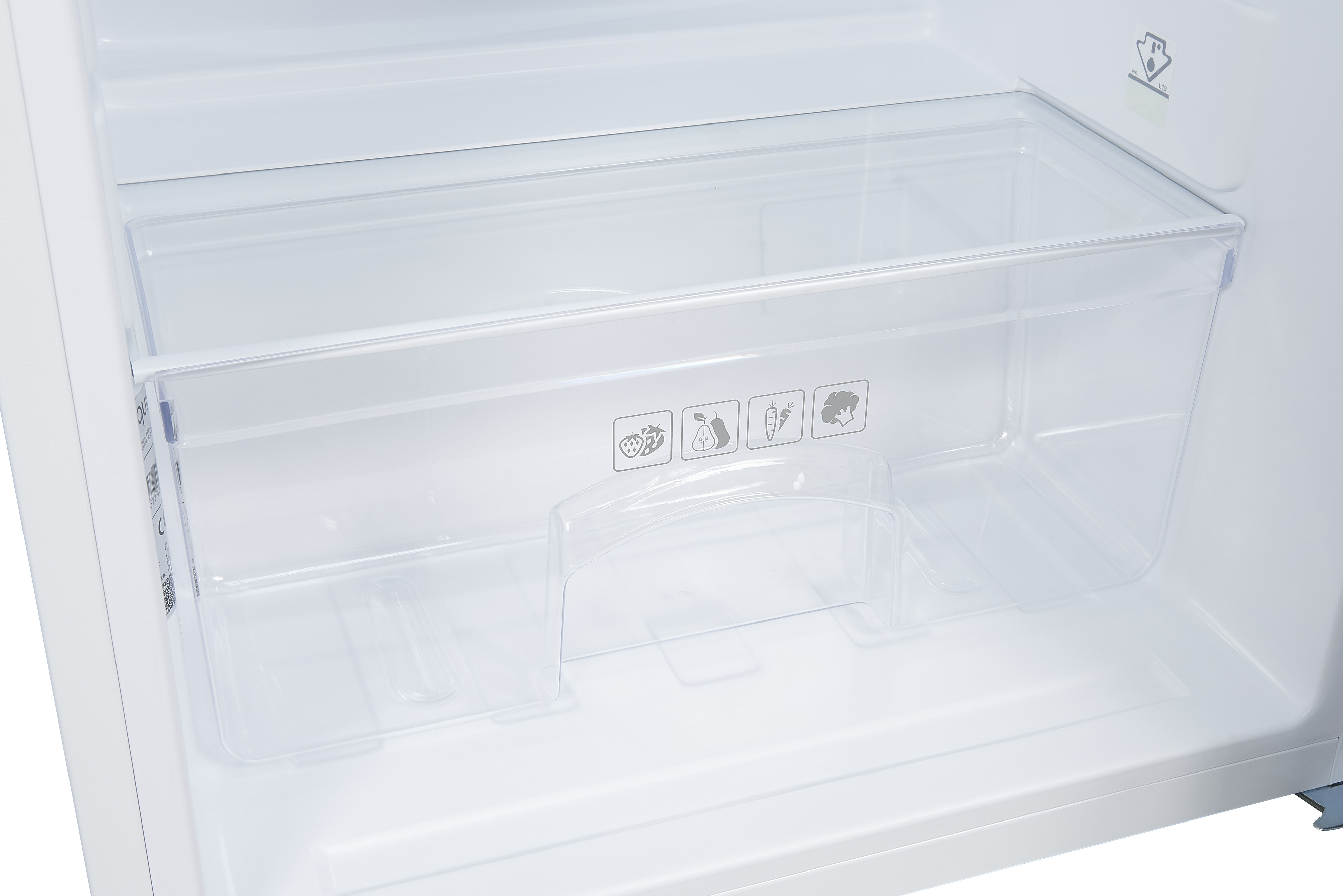 Inside of a refrigerator. There is a transparent drawer with produce icons, and a shelf above.