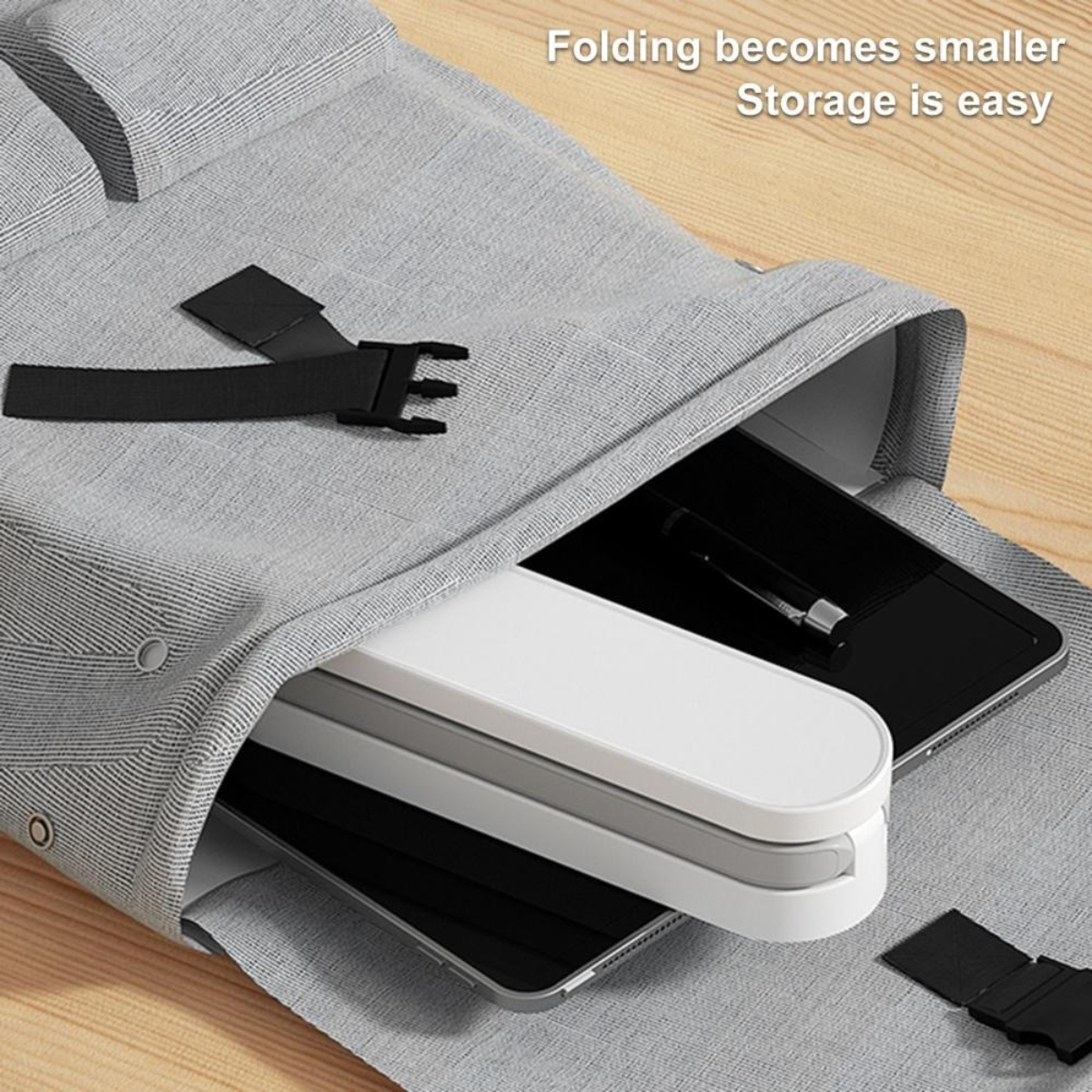 Bolsa gris abierta. Dentro: tabletas, bolígrafos y accesorios. Texto: Plegado se reduce, el almacenamiento es fácil.