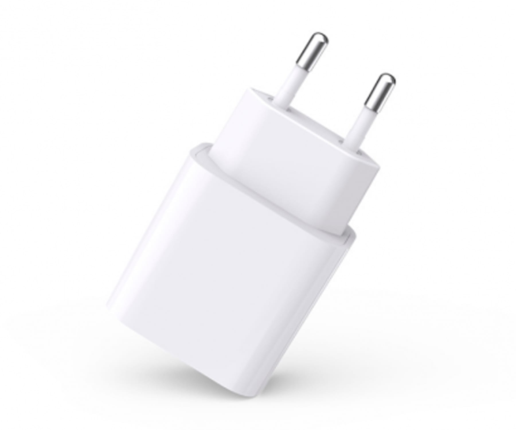 Adaptador de carga blanco con clavijas. Aislado sobre un fondo blanco, con una ligera sombra.