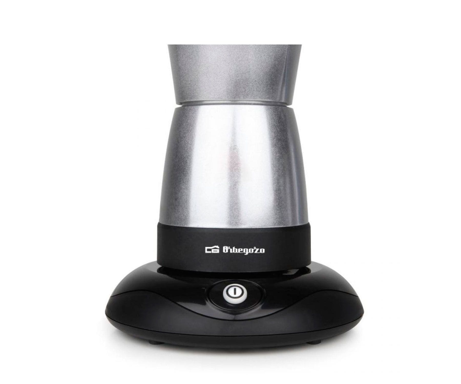 Srebrne i czarne urządzenie z przyciskiem. Białe tło.