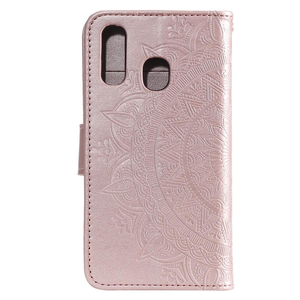 Eine rosa Handyhülle mit Mandala-Design, geschlossen. Die Handyhülle ist aus Leder.