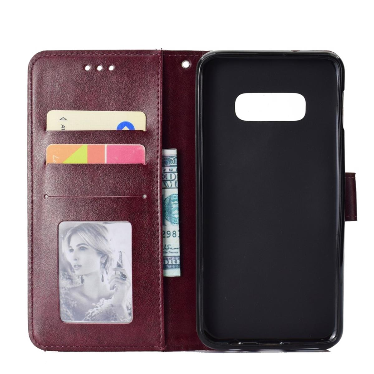 Offenes weinrotes Wallet Case mit Karten, Bargeld und Foto. Schwarzes Handycase darin.
