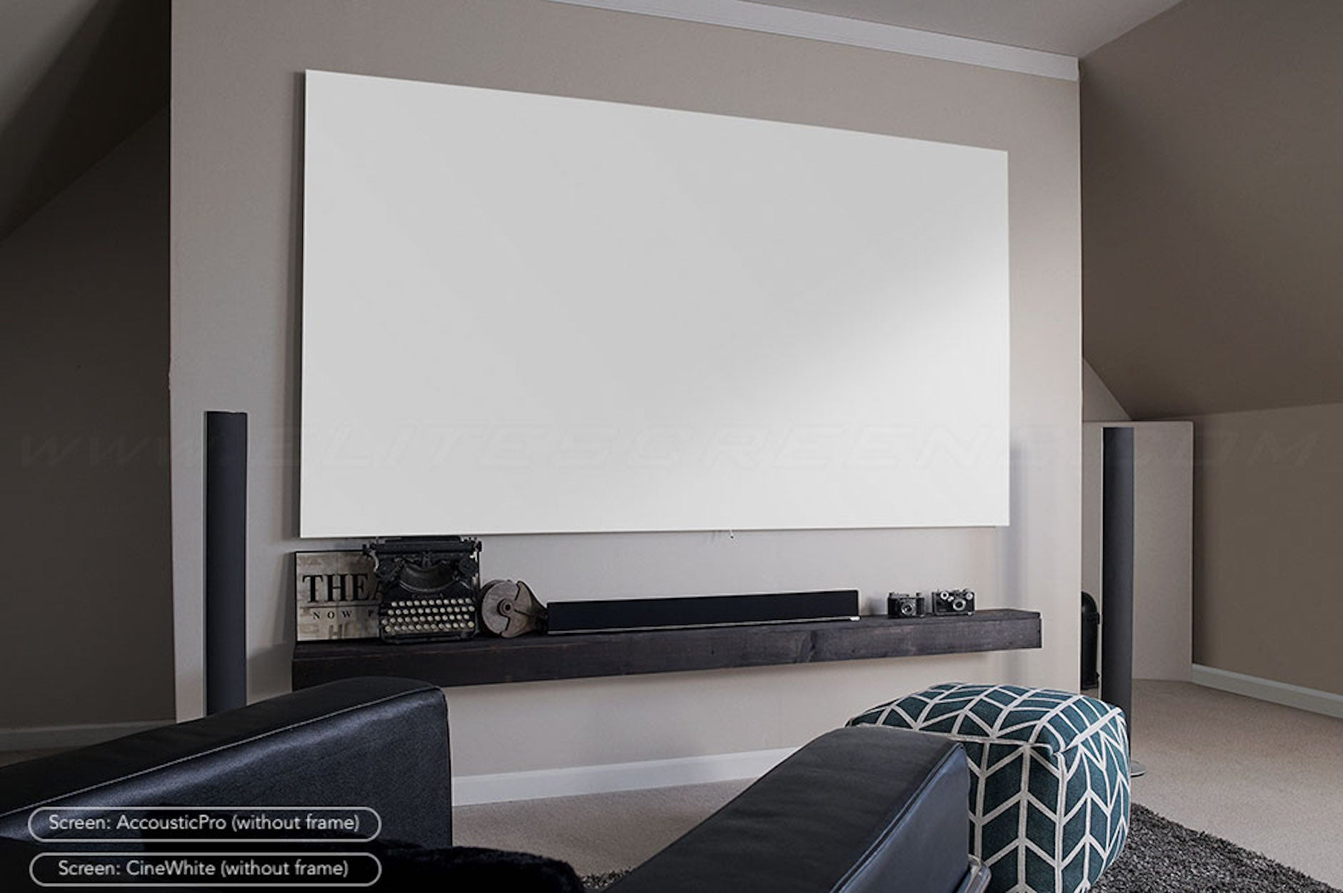 A large white projector screen is mounted on a wall. A shelf with items is below it.