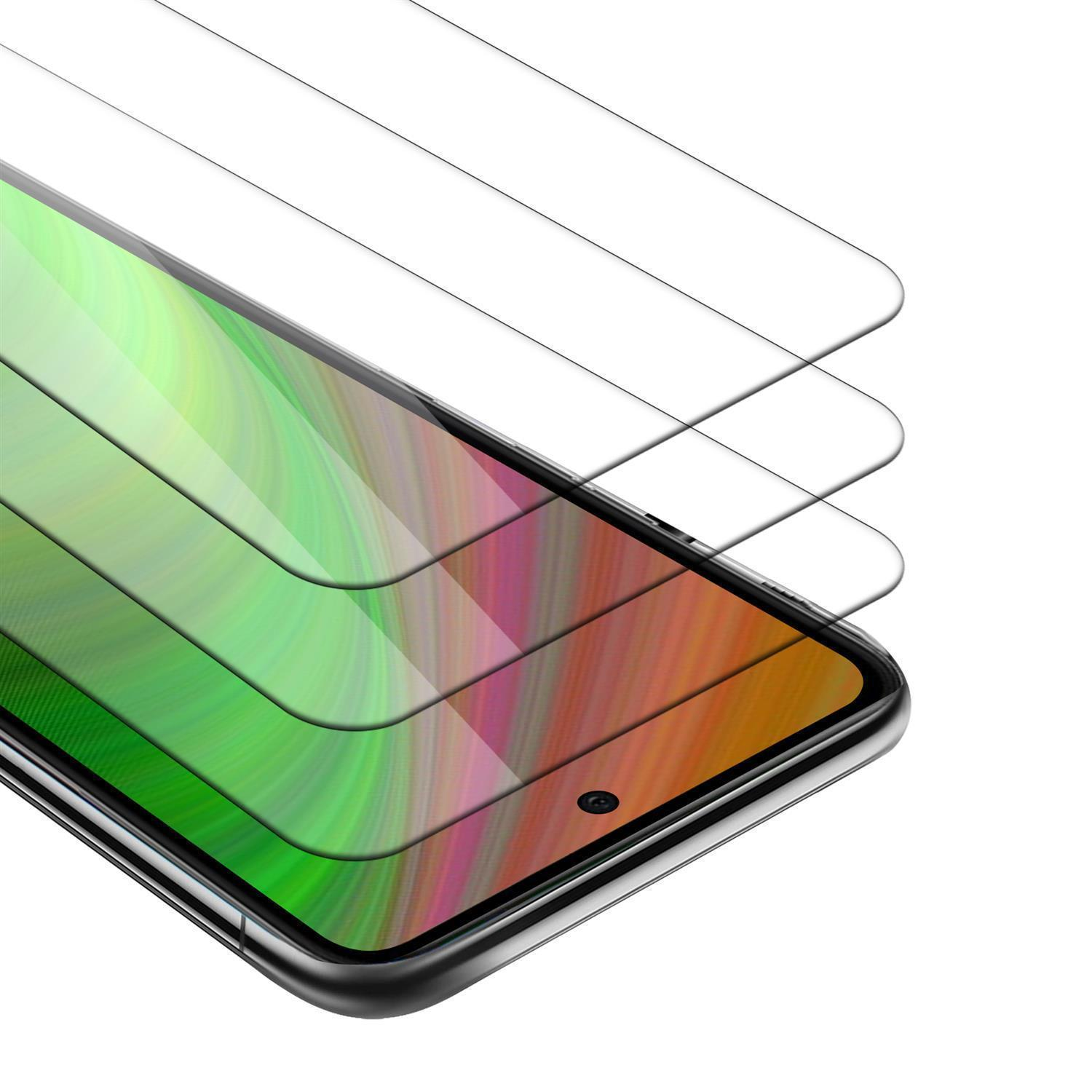 Tre protezioni per lo schermo. Il telefono è visibile attraverso le protezioni, con sfondo verde e viola.