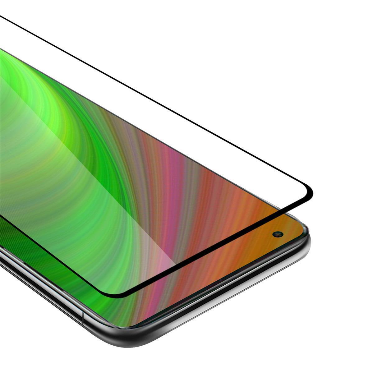 Smartphone con protezione schermo applicata. Il telefono ha una cornice nera. È visibile uno sfondo verde e arancione.