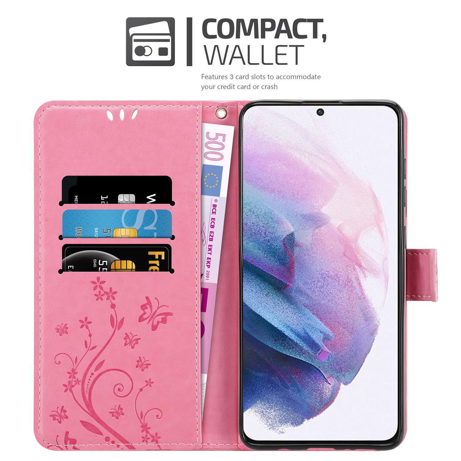 Custodia a portafoglio rosa con telefono. Ha slot per carte e una banconota da 500 euro. Lo schermo è acceso.