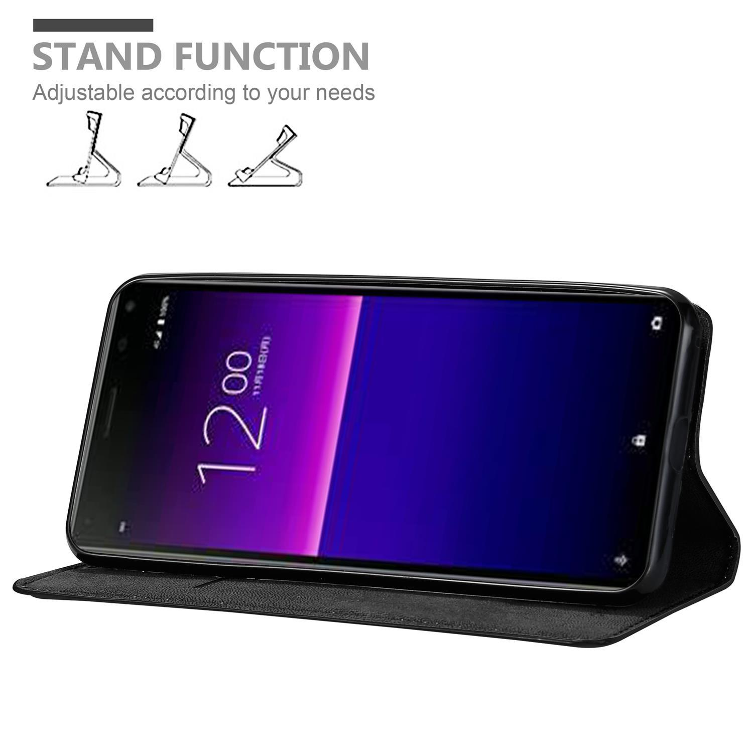 Telefon in einem Gehäuse, das die Uhrzeit anzeigt. Standfunktion und Diagramme werden angezeigt.