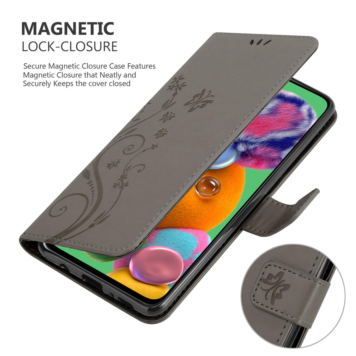 Custodia grigia aperta, mostra un telefono. Design floreale e chiusura magnetica visibili. Schermo acceso.