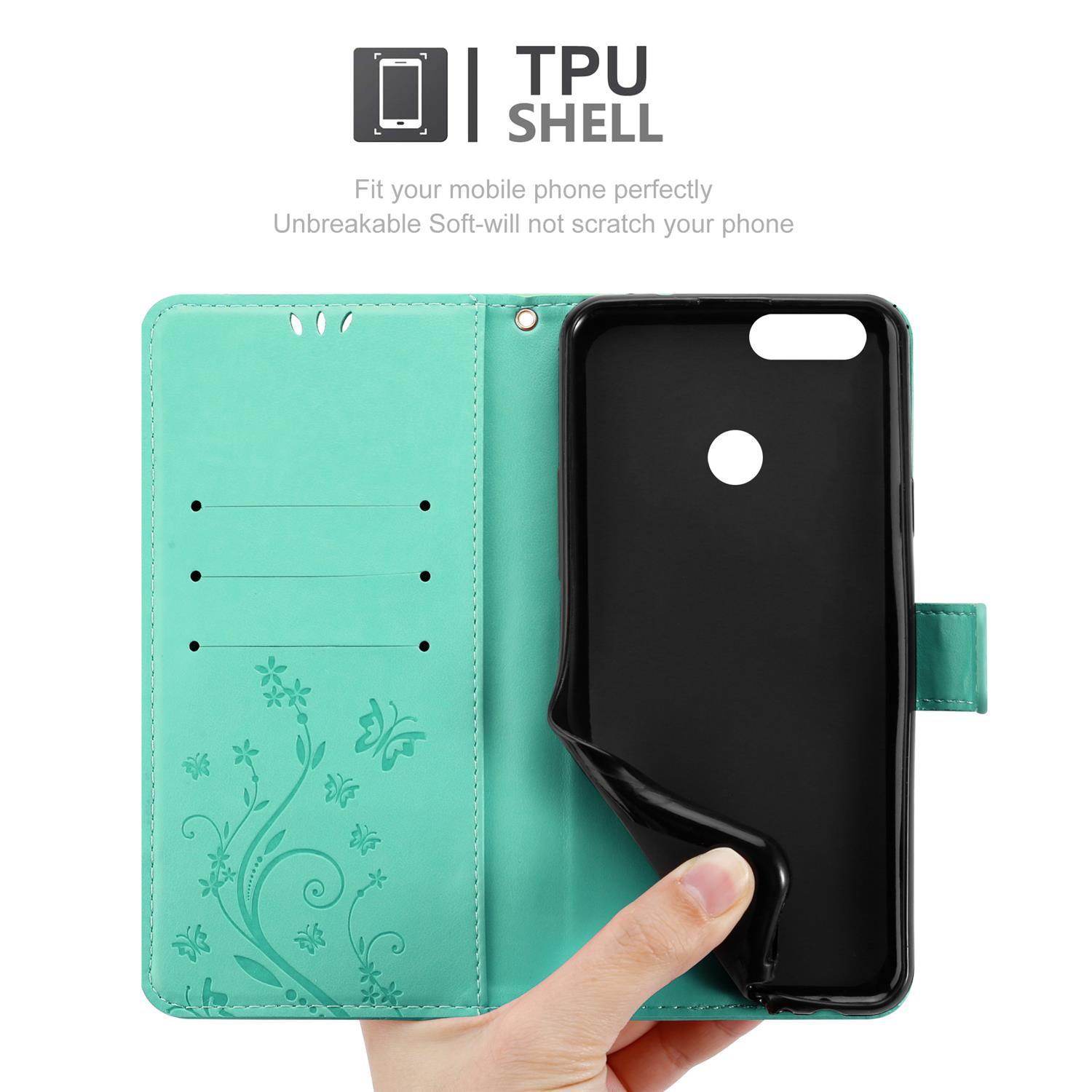 Una mano che tiene una custodia per telefono verde acqua con un telefono nero all'interno.