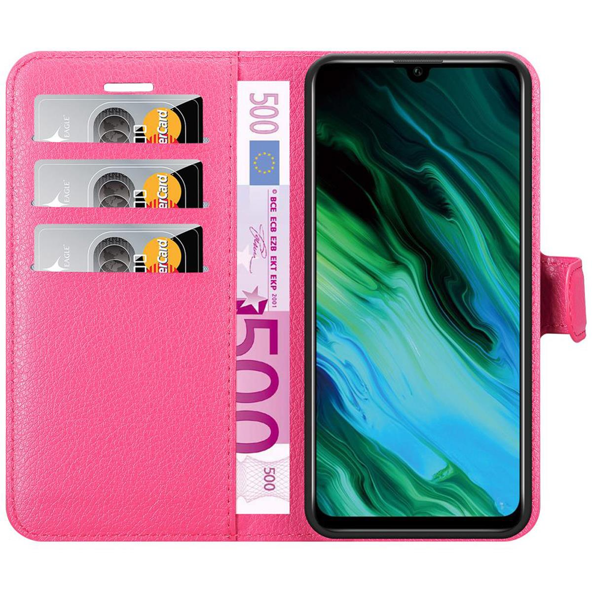 Custodia per telefono rosa con carte di credito e una banconota da 500 euro all'interno. Un telefono è a destra.