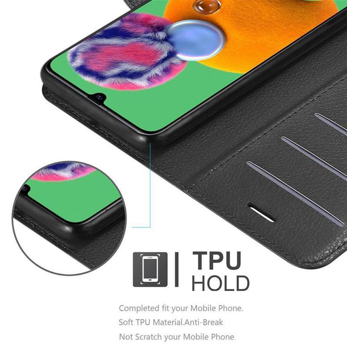 Telefono in una custodia a portafoglio. Testo: TPU Hold. Carta nella fessura. Custodia nera.