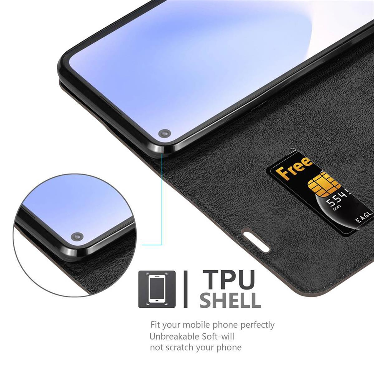 Un teléfono está en una funda negra, con una tarjeta. El texto 'TPU SHELL' está en la parte inferior.