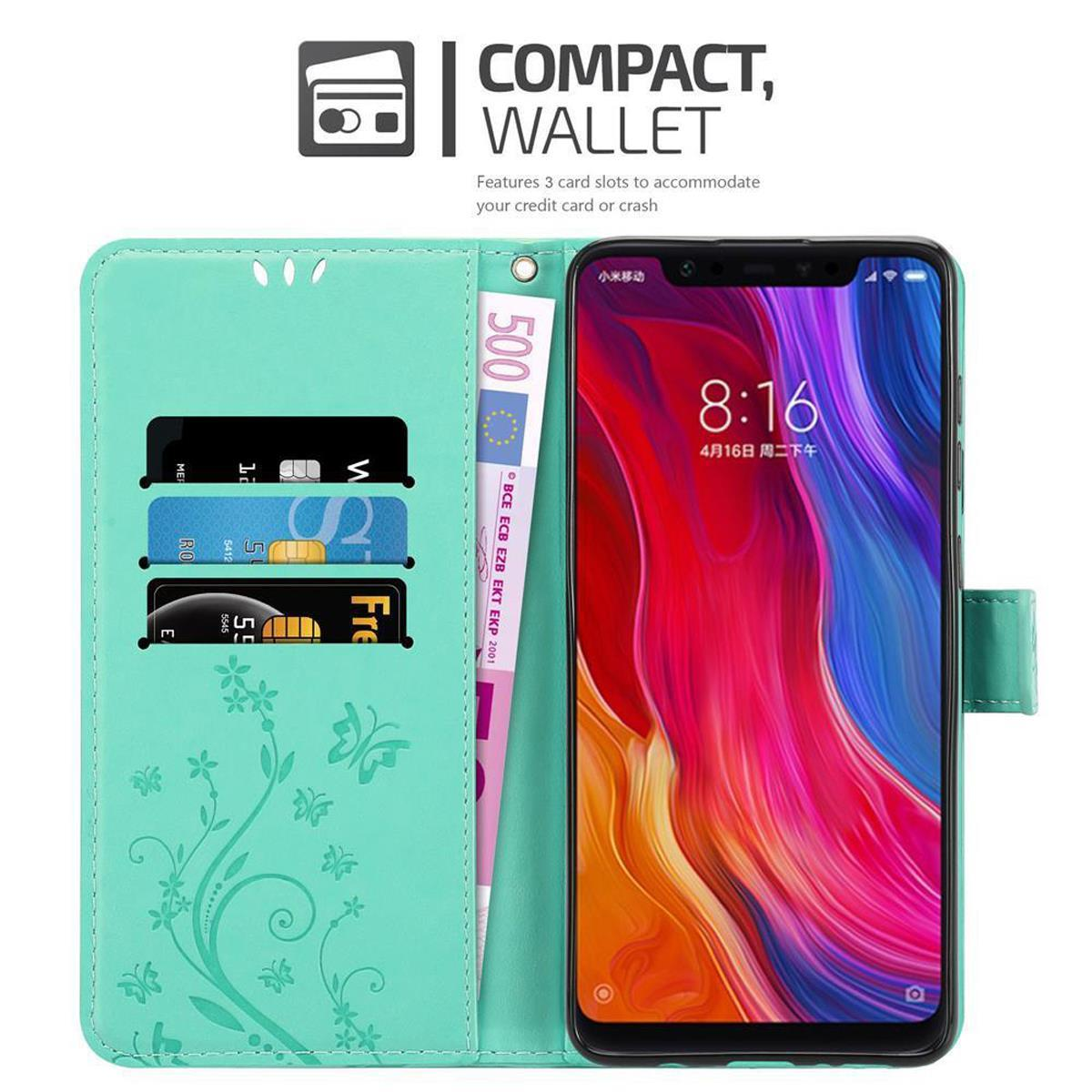 Custodia turchese con telefono, carte, denaro e testo sul portafoglio.