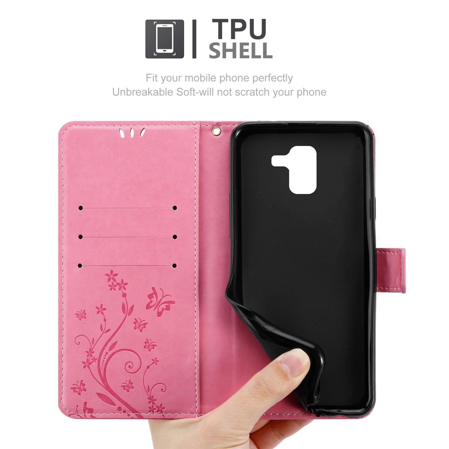 Rosafarbene Handyhülle offen, zeigt ein schwarzes Telefon. Die Hülle hat Blumendesign und Kartenfächer, gehalten von einer Hand.