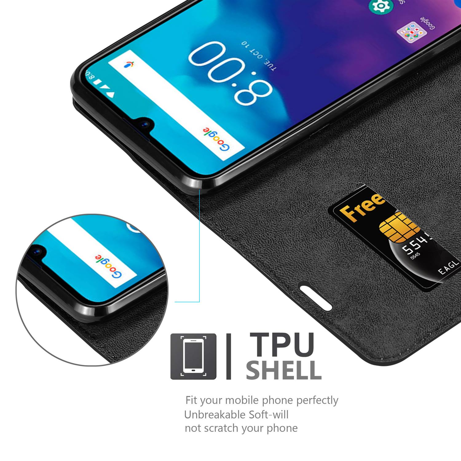 Custodia per telefono nera, aperta, che mostra lo schermo del telefono. È visibile una scheda SIM. Testo: 'TPU SHELL'.