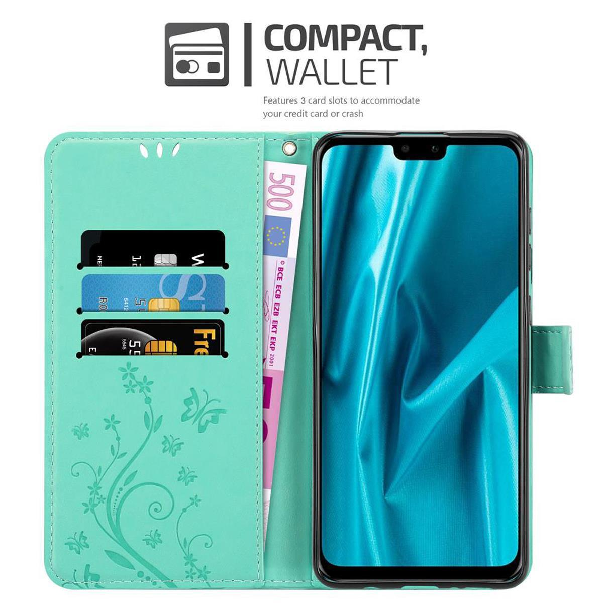 Funda de teléfono con teléfono, tarjetas de crédito y dinero. La funda está abierta y es de color turquesa.