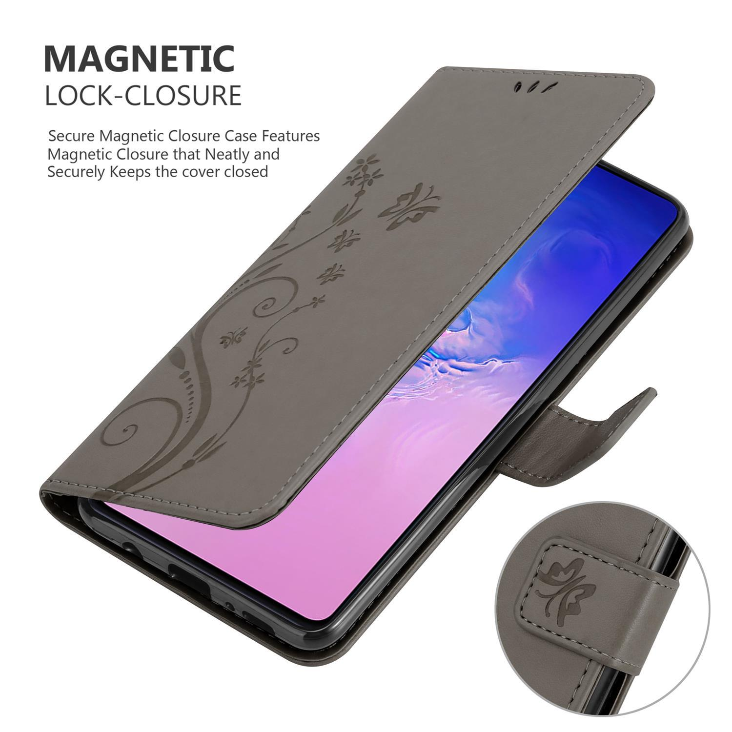 Custodia grigia per telefono con design floreale. Il telefono è visibile all'interno della custodia aperta. È presente la chiusura magnetica.