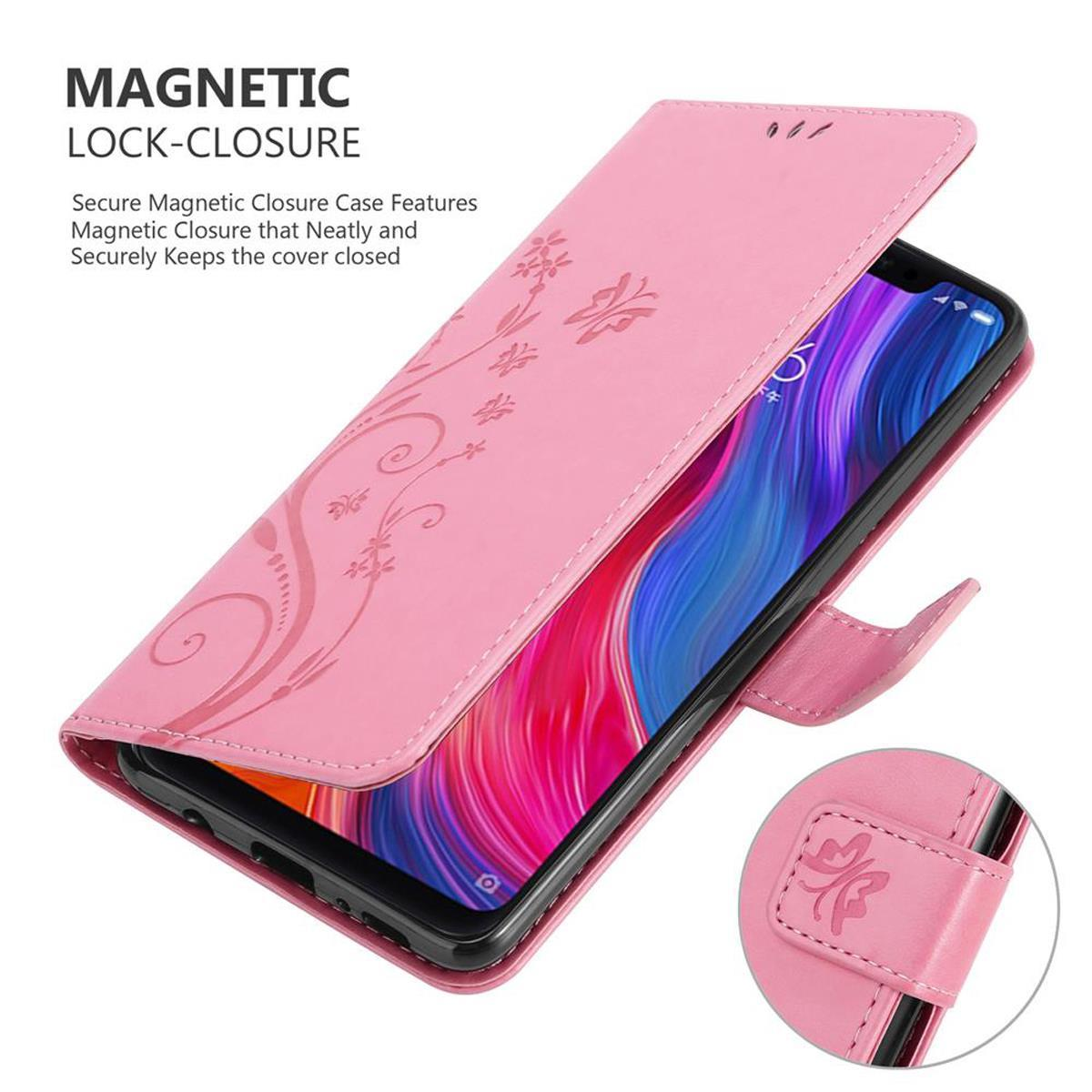Custodia per telefono rosa aperta, che rivela un telefono nero. La custodia ha motivi floreali e una chiusura magnetica.