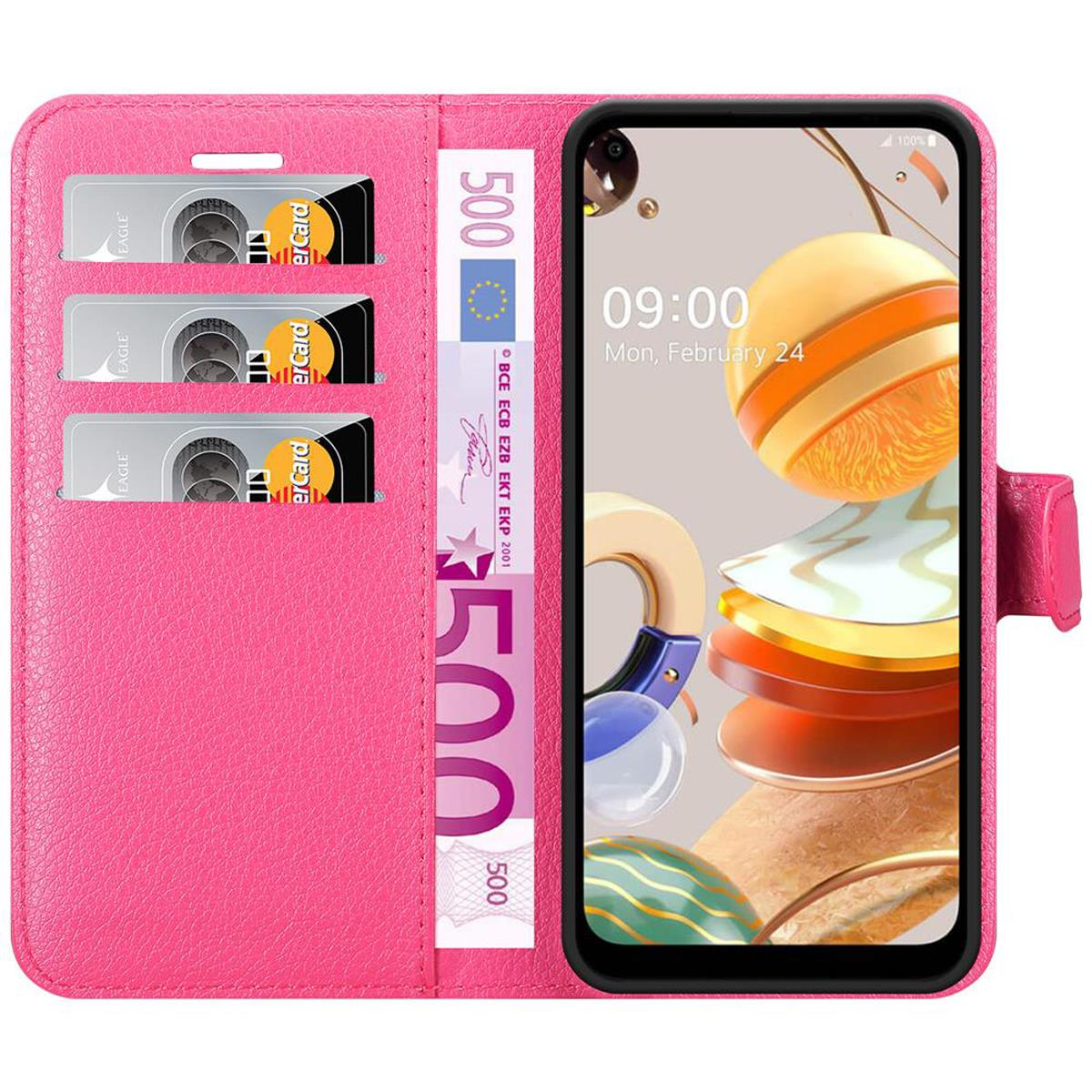 Una custodia rosa con telefono, carte di credito e banconota da 500 euro.