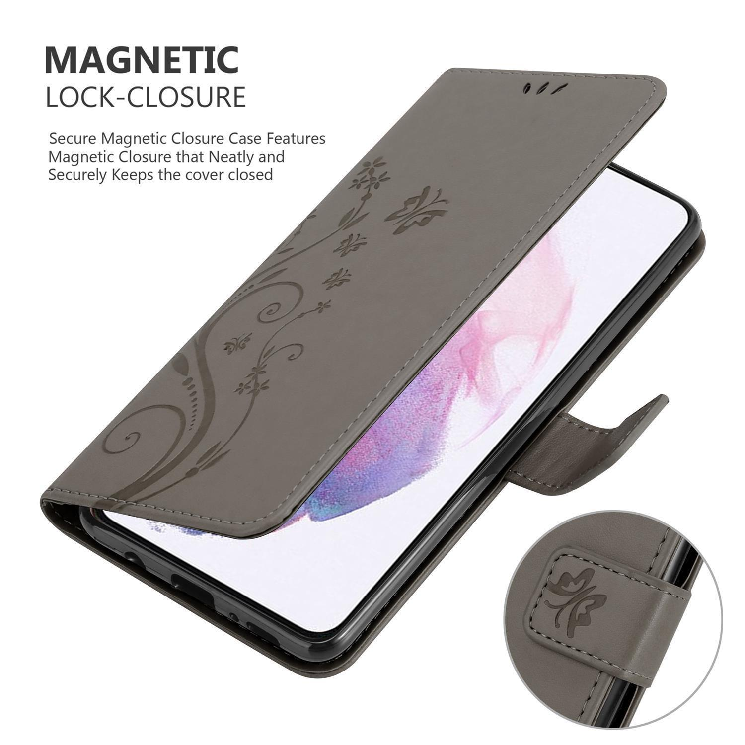 Una custodia grigia per telefono con un design floreale, aperta per rivelare un telefono. La custodia ha una chiusura magnetica.