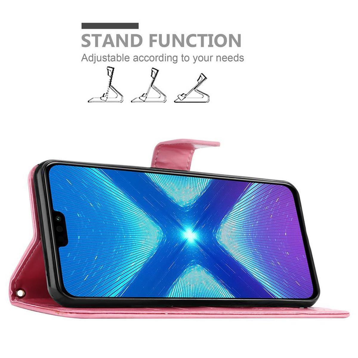 Telefono in una custodia a portafoglio rosa, appoggiato in posizione di supporto. Il telefono ha uno schermo blu e bianco.