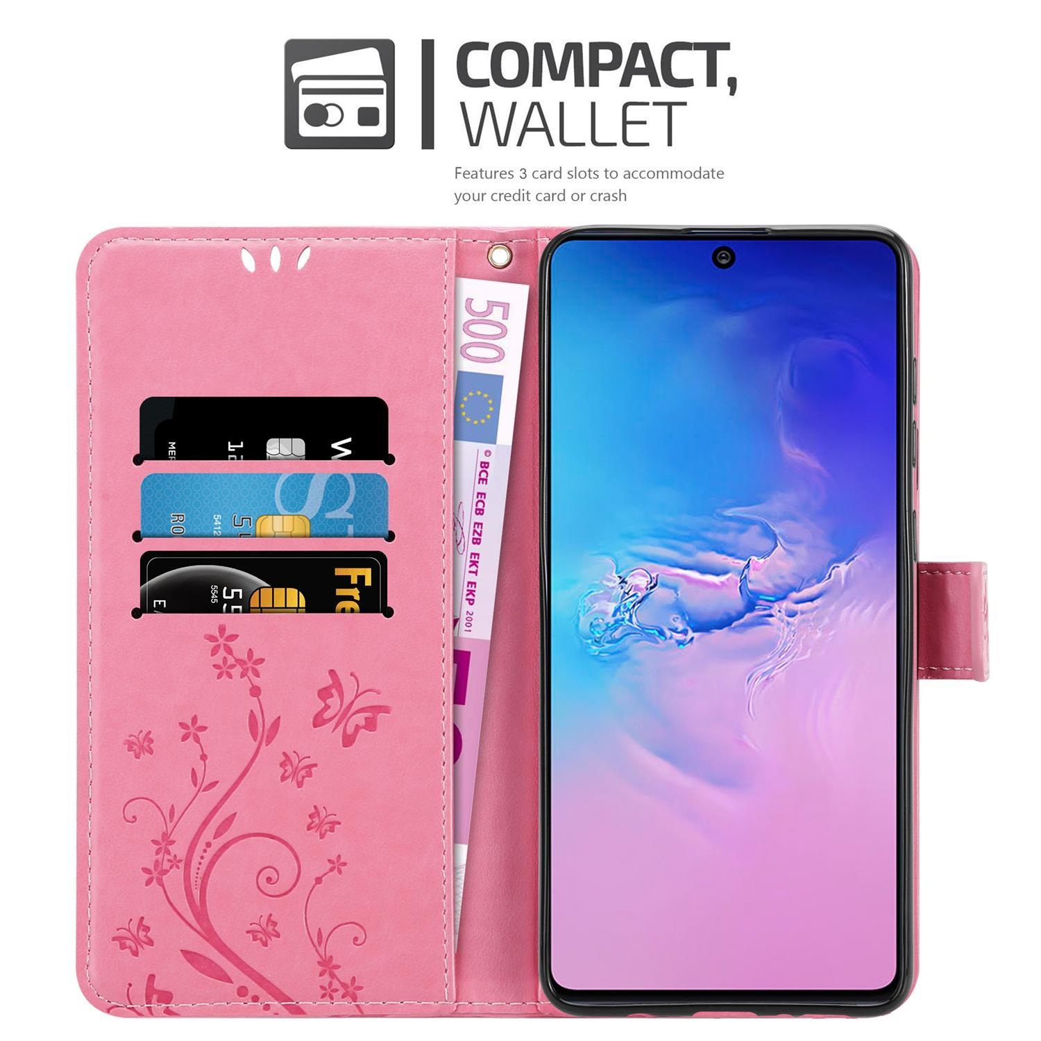 Custodia rosa per telefono aperta con telefono e carte all'interno. La custodia ha un design floreale e un portafoglio.