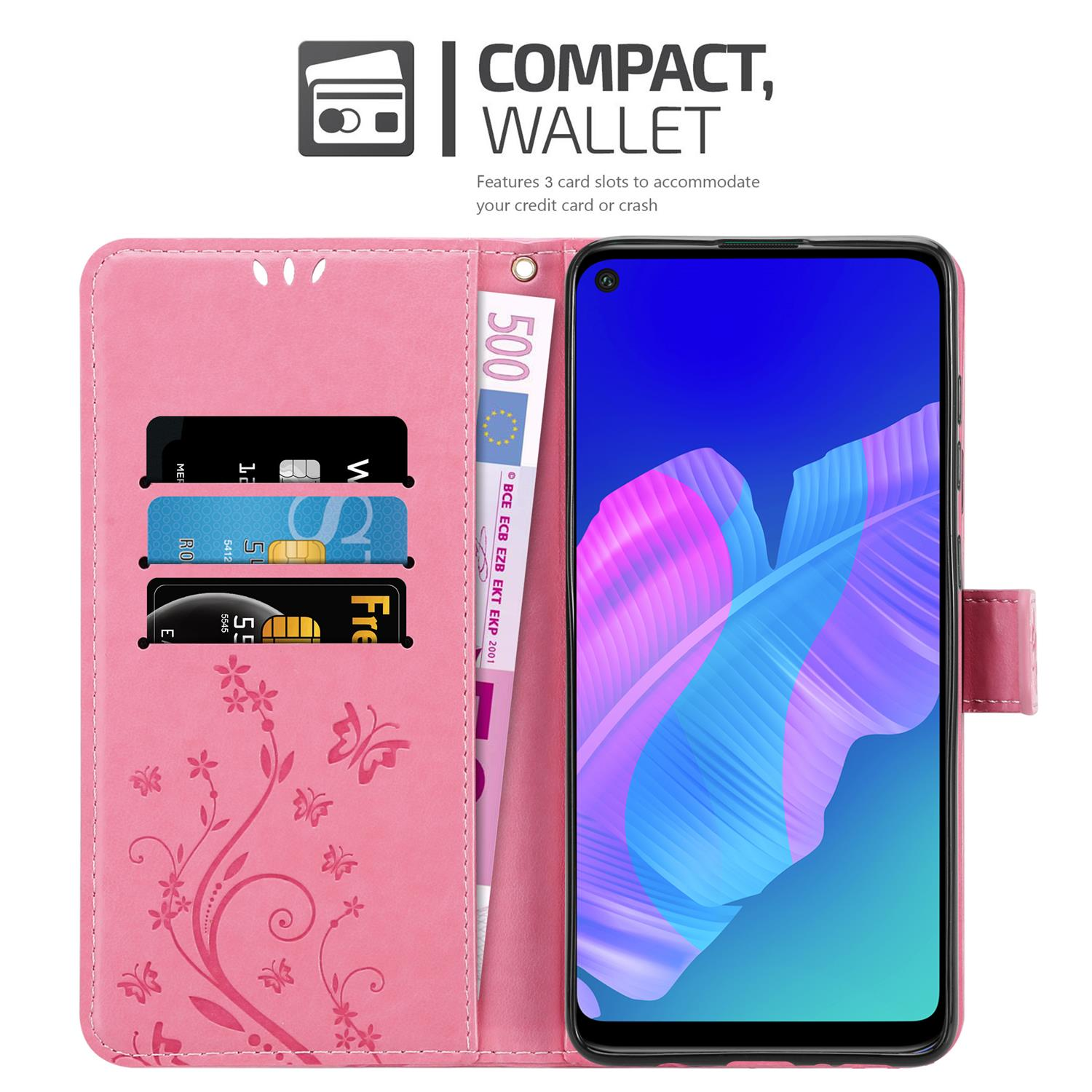 Una custodia rosa è aperta, mostrando un telefono e scomparti per carte con denaro. La custodia è decorata.