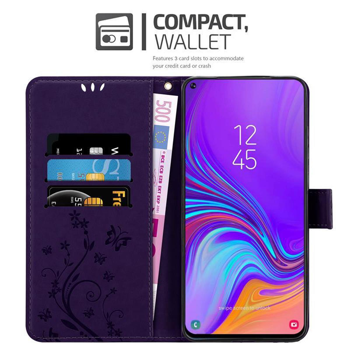 Custodia a portafoglio viola aperta, che mostra telefono e fessure per carte con carte e una banconota da 500 euro.