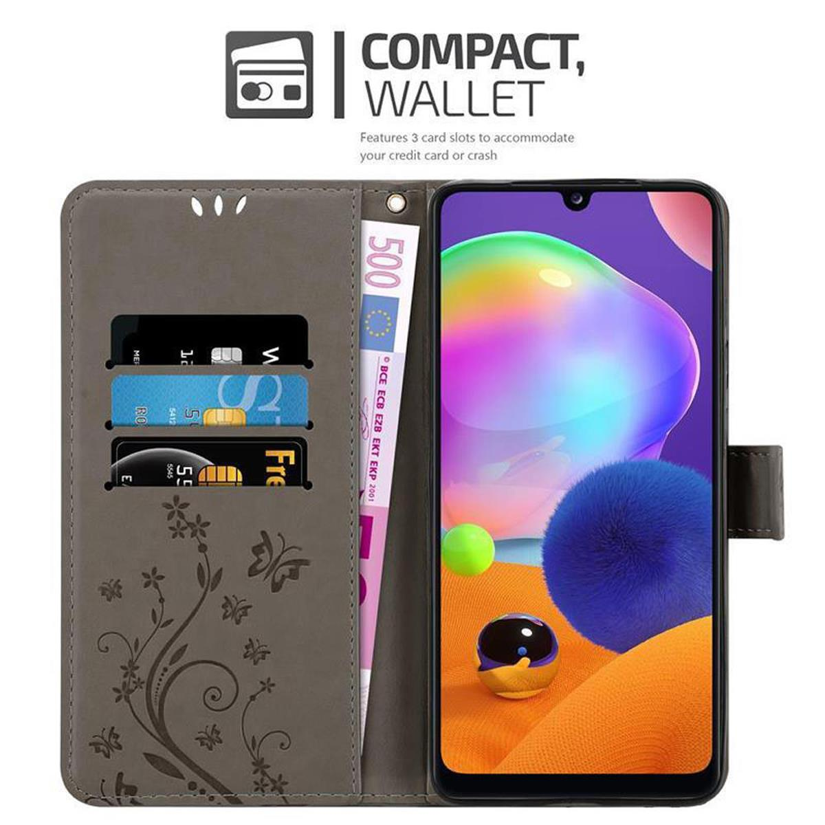 Un telefono in una custodia a portafoglio. All'interno ci sono carte di credito e una banconota da 500 euro. La custodia ha un design floreale.