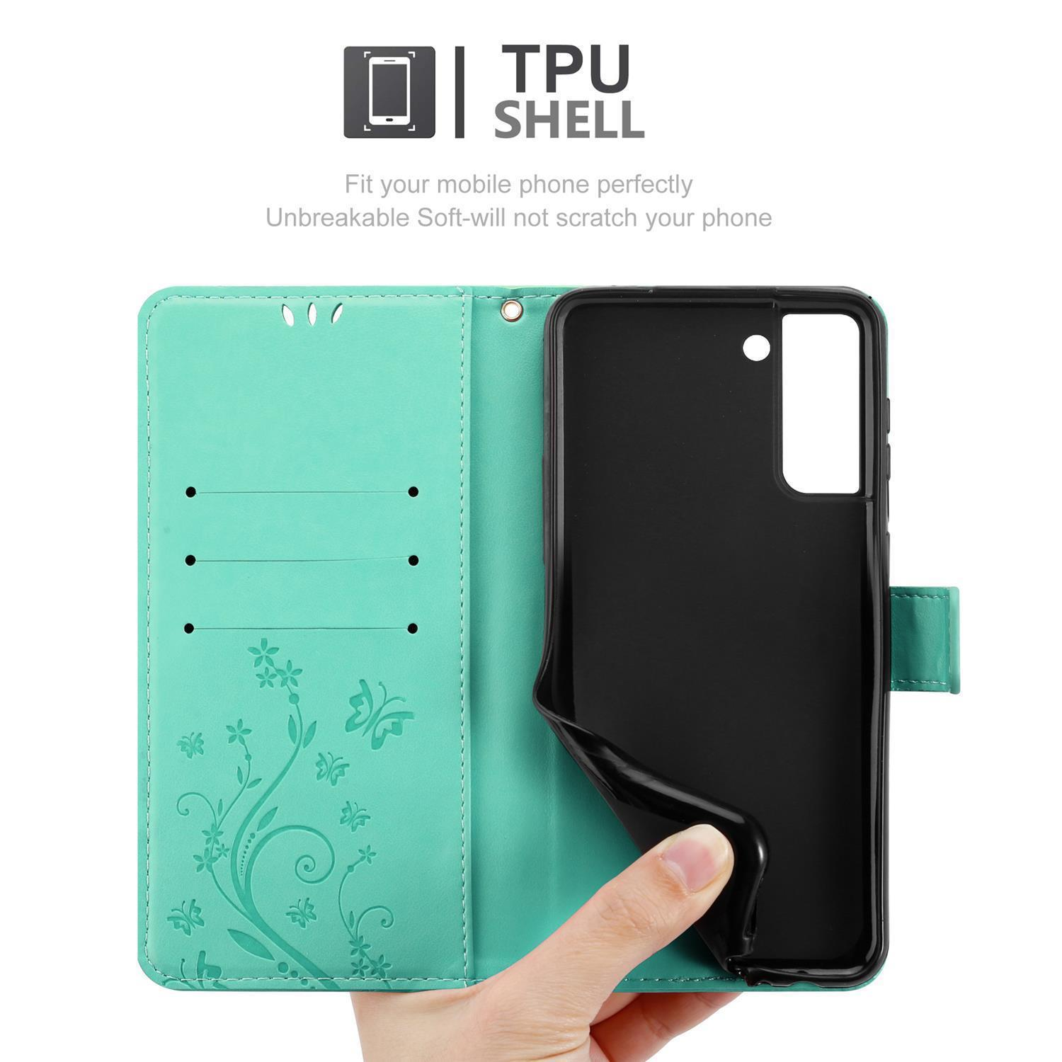 Custodia per telefono verde acqua aperta con mano che tiene il telefono. Guscio in TPU con motivo floreale a farfalla.