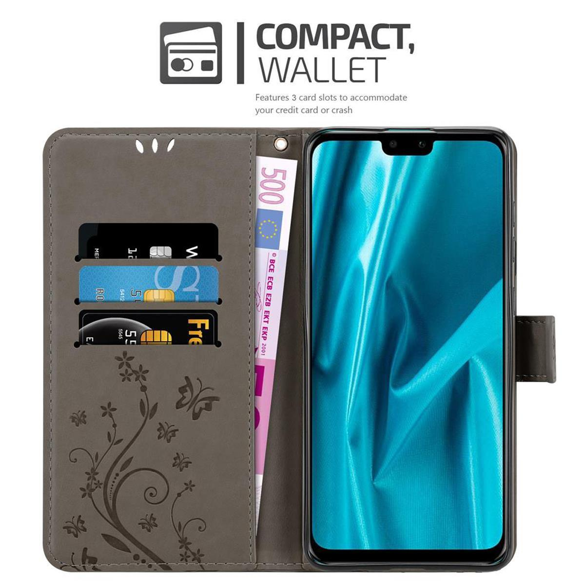 Funda de teléfono gris con teléfono dentro. Tiene ranura para tarjetas y billete de 500 euros. La funda está abierta.