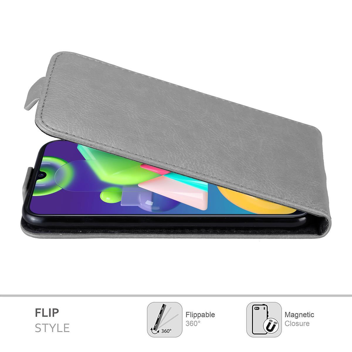 Graue Handyhülle mit Telefon, Flip-Stil. Telefon ist im Inneren sichtbar. Verfügt über Magnetverschluss.