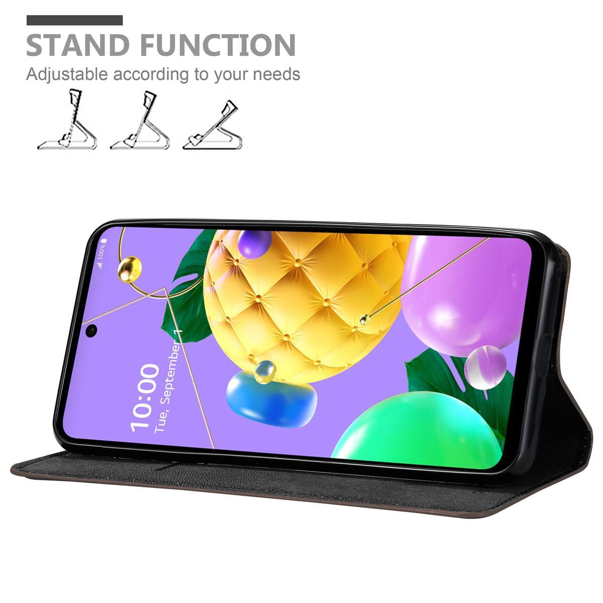Telefono nero in una custodia, puntellato. Lo schermo mostra forme astratte colorate. Viene pubblicizzata la funzione supporto.