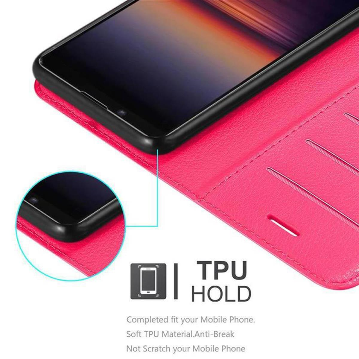 Custodia rosa per telefono, aperta, con telefono dentro. Testo: TPU HOLD.
