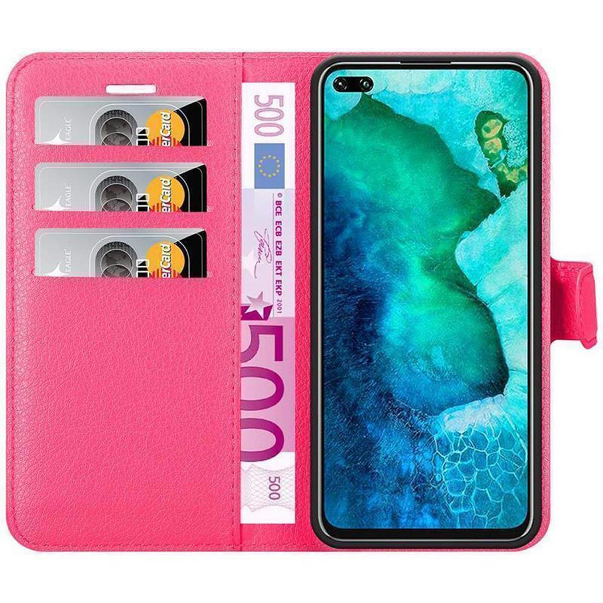 Custodia a portafoglio rosa aperta con carte di credito e denaro. Il telefono mostra un'immagine colorata.