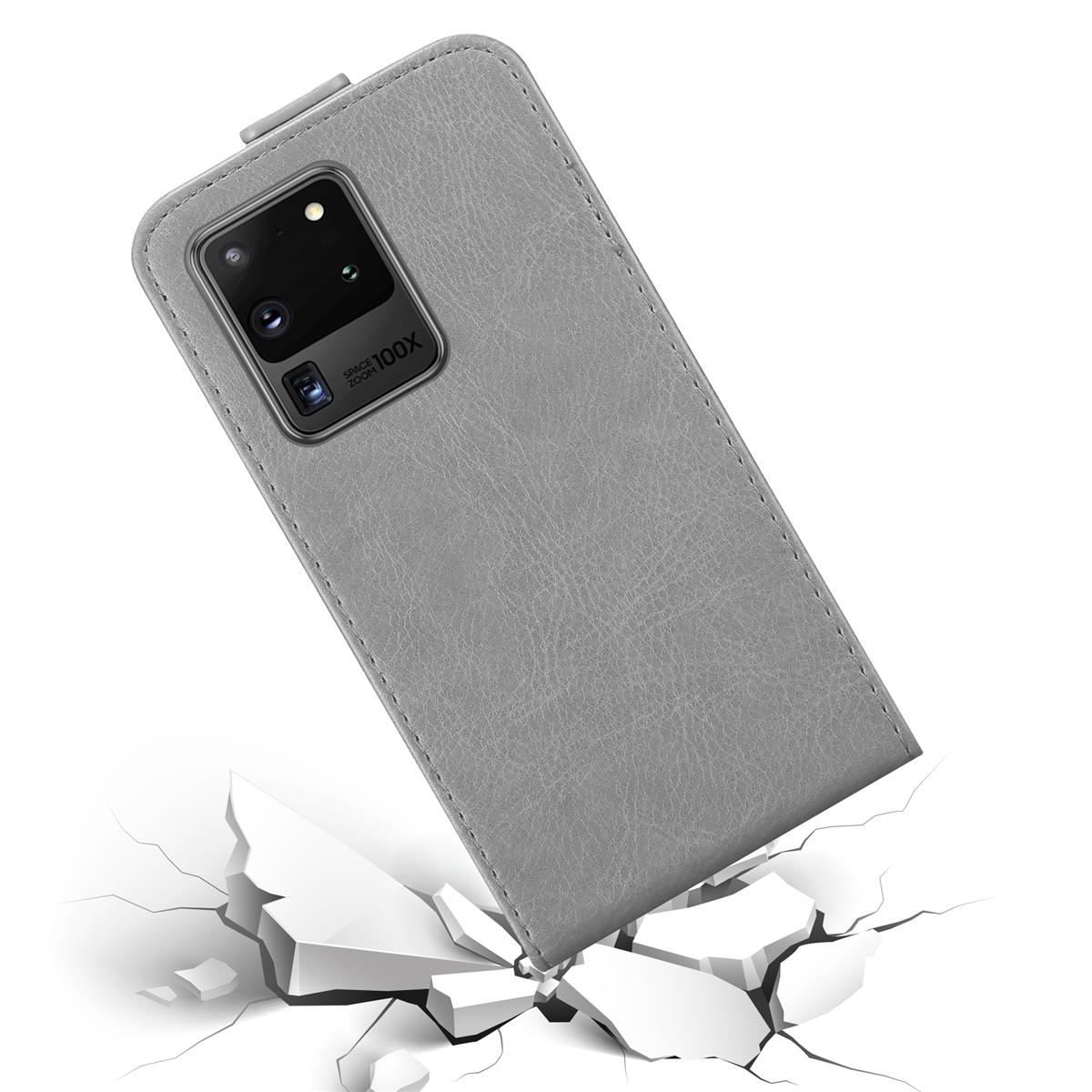 Custodia grigia con telefono. Cemento rotto sullo sfondo.