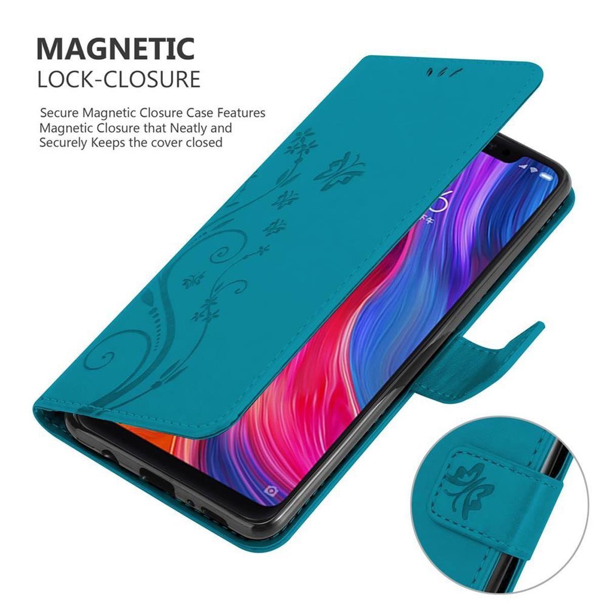 Custodia per telefono turchese, aperta, con schermo visibile. Design floreale sulla custodia.