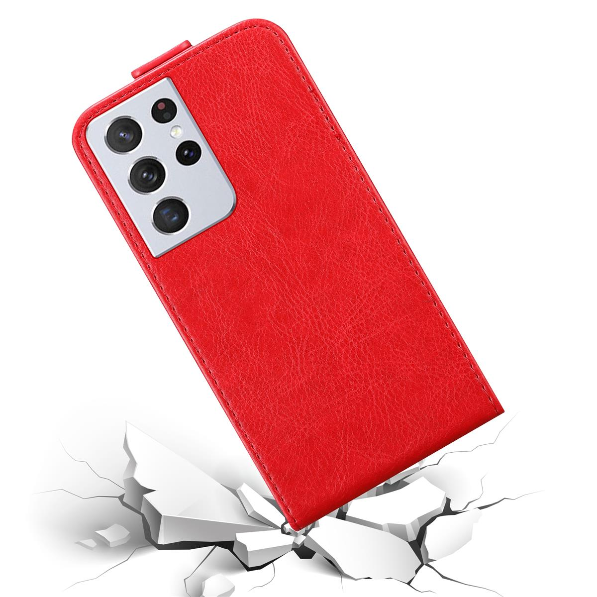 Custodia rossa, con telefono dentro, cade su superficie bianca, mostrando crepe.