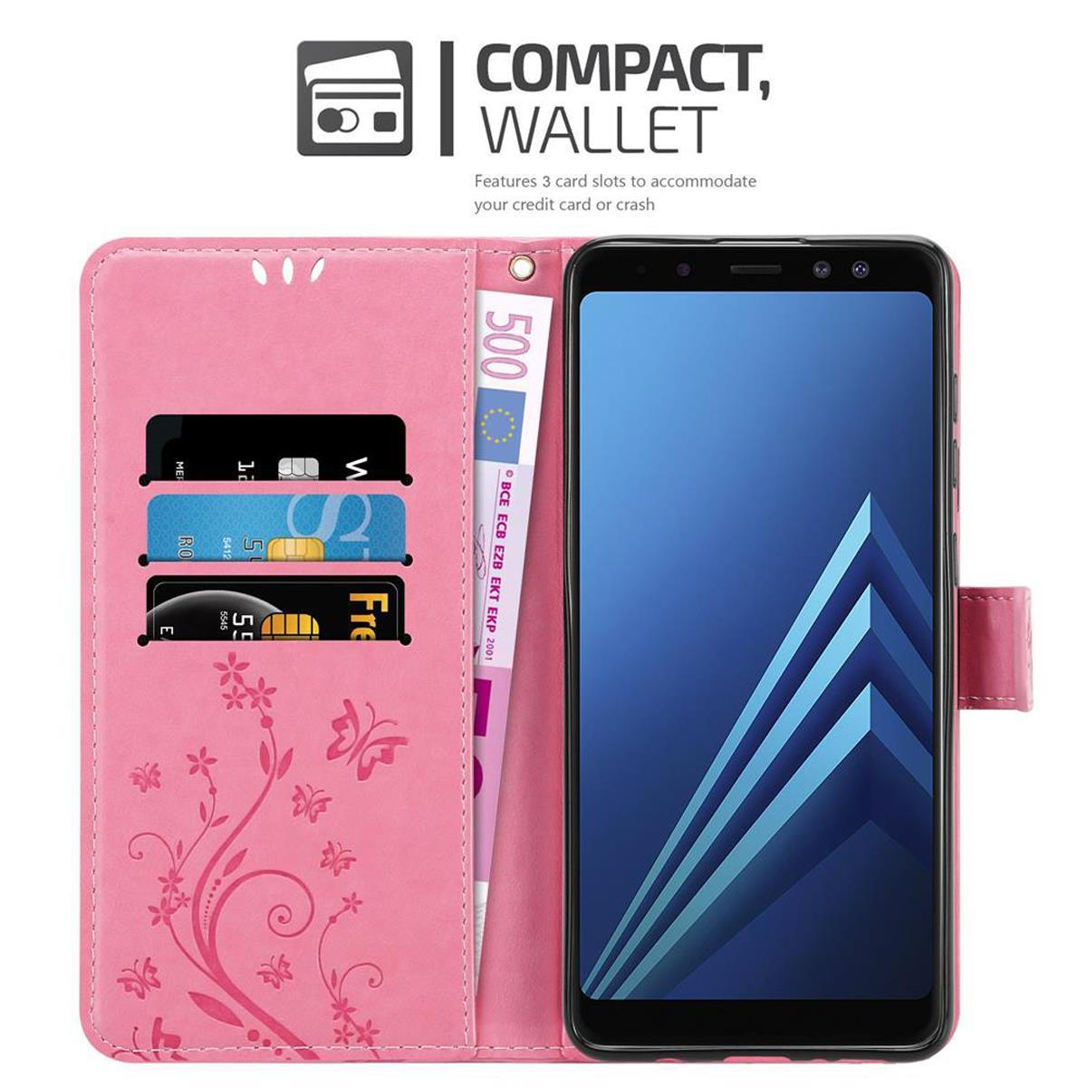Custodia rosa con telefono e carte. Fiori e cinturino. Banconota da 500 euro.
