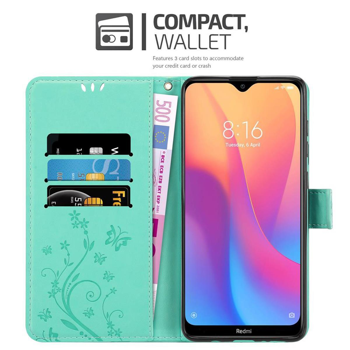 Minzfarbene Handyhülle mit Telefon, Karten und Geld. Weißer Hintergrund.