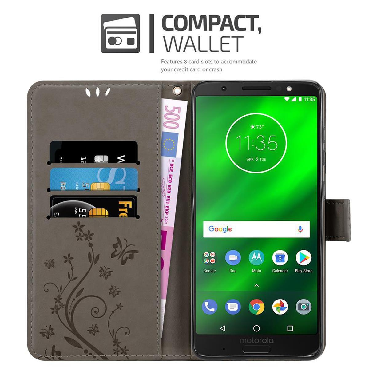 Un telefono in una custodia a portafoglio grigia, che mostra carte e denaro. Il telefono ha uno schermo verde.
