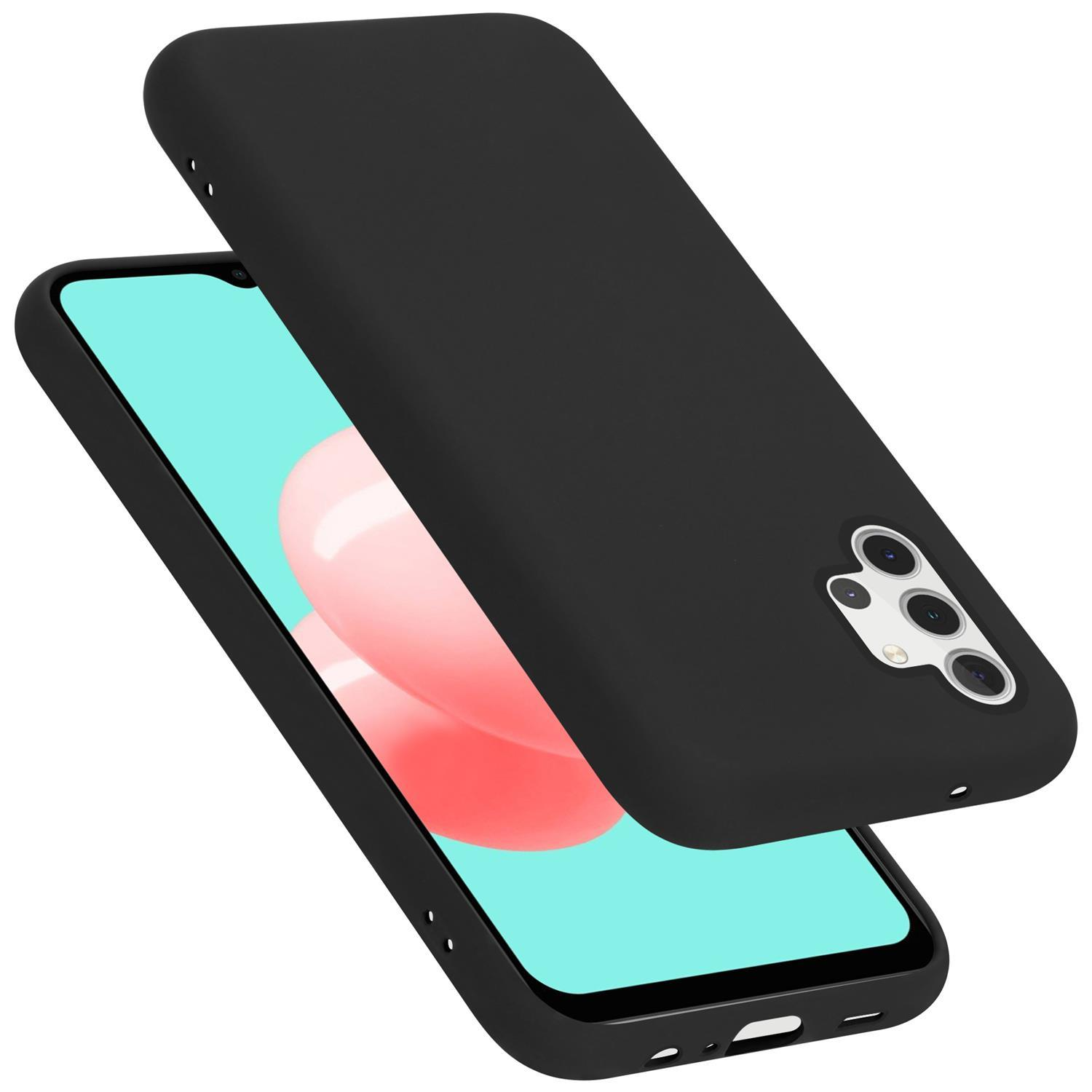 Schwarze Handyhülle, mit geöffnetem Telefon, das einen rosa und weißen Hintergrund zeigt.