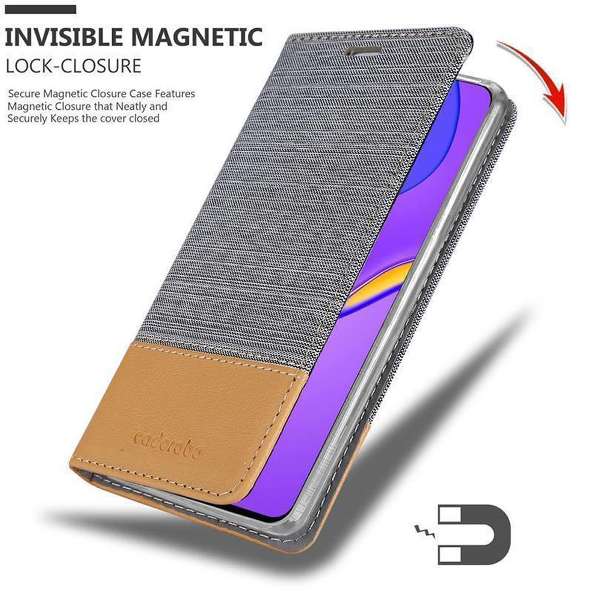 Custodia per telefono con chiusura magnetica. La custodia è grigia con una patta in pelle marrone. Viene mostrato un magnete.